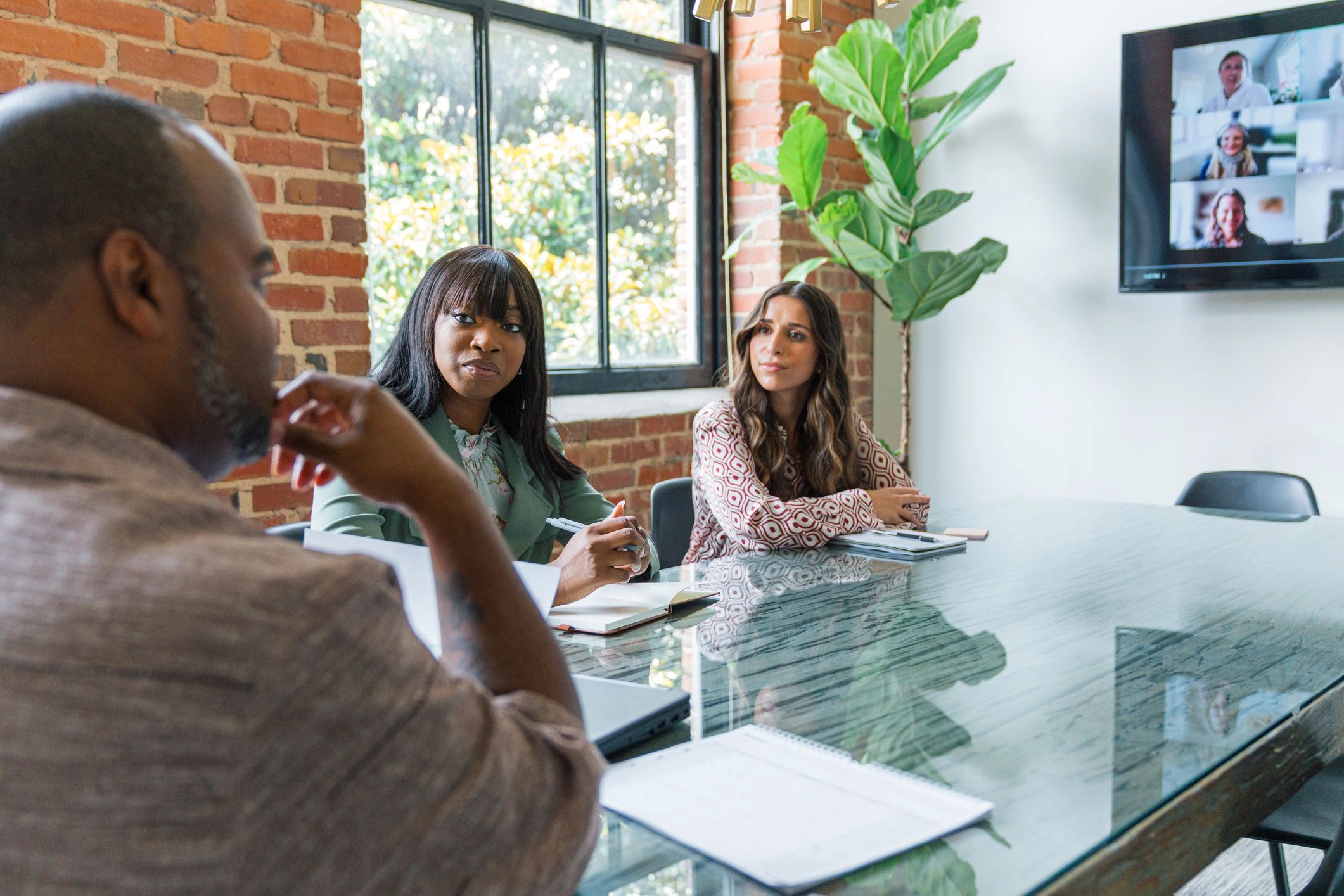 Editorial team collaborating in a modern newsroom meeting