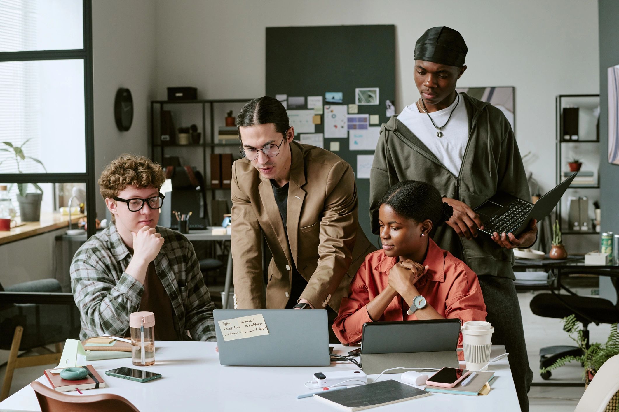 Editorial team reviewing digital coverage together